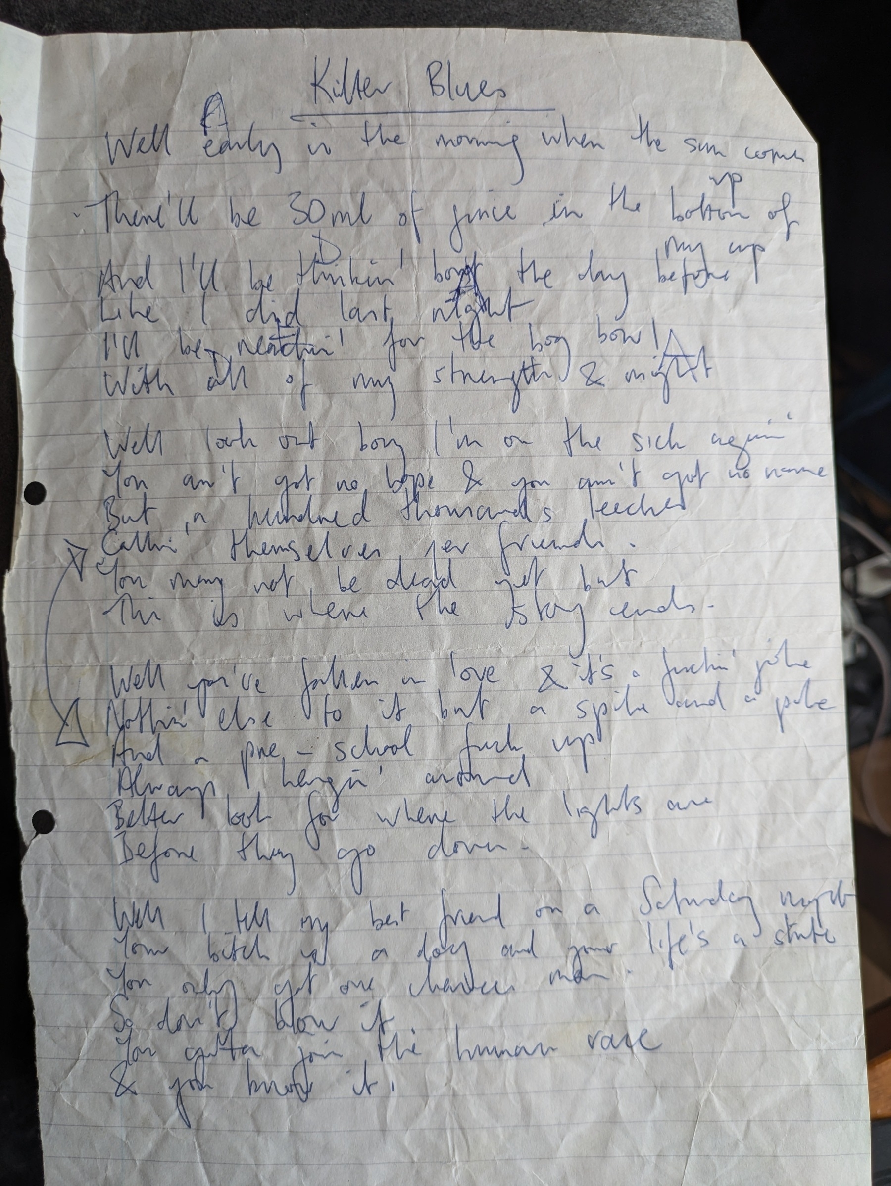 Handwritten lyrics on lined paper